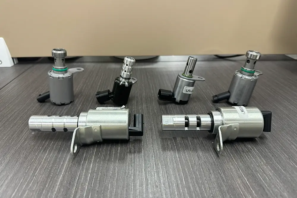 Different VVT solenoid valve designs showing variations in connectors, valve bodies and mounting structures