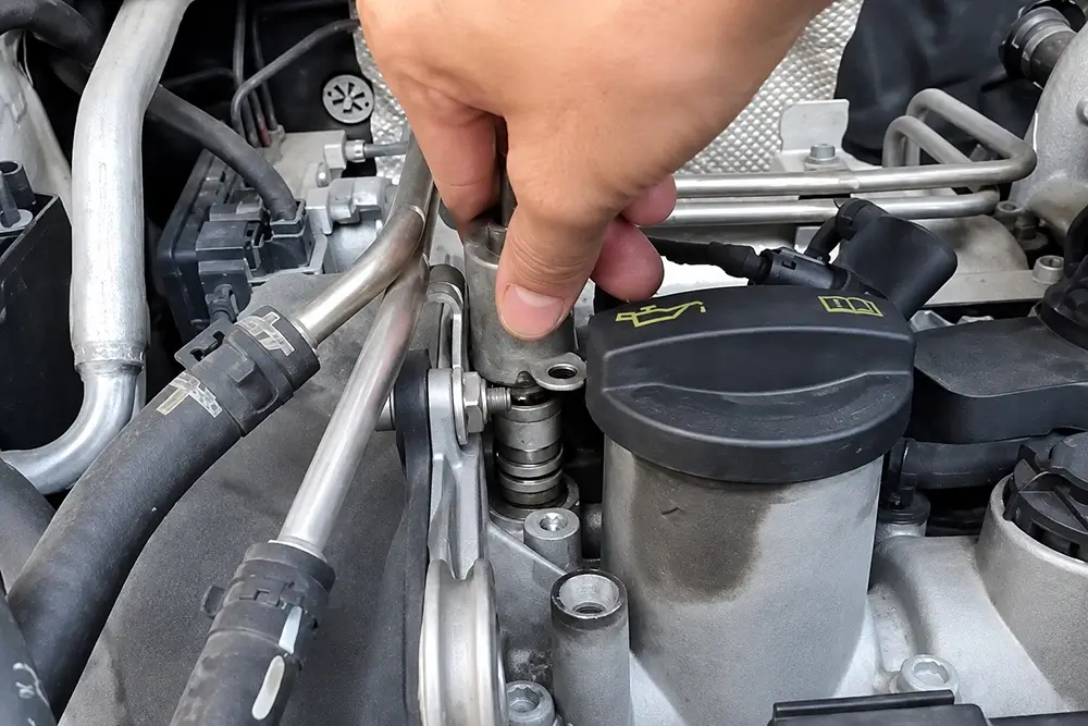 VVT solenoid installed in the cylinder head area of an engine